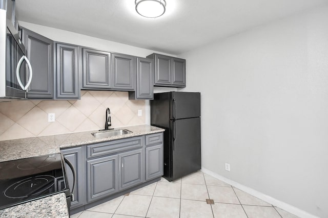 kitchen with backsplash, black appliances, sink, gray cabinets, and light tile patterned floors