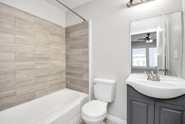 full bathroom with vanity, tiled shower / bath combo, toilet, and ceiling fan