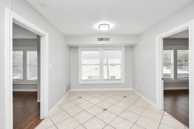 spare room featuring plenty of natural light and light wood-type flooring