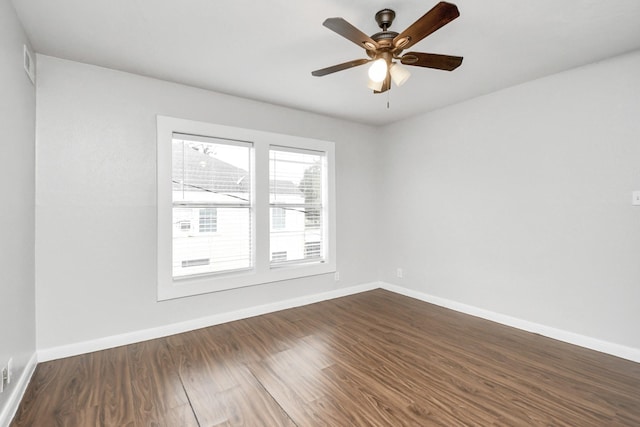 spare room featuring dark hardwood / wood-style floors and ceiling fan