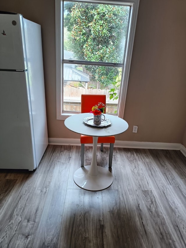 unfurnished dining area featuring hardwood / wood-style flooring and a healthy amount of sunlight