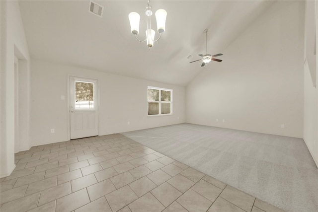 unfurnished living room with light carpet, high vaulted ceiling, and ceiling fan with notable chandelier