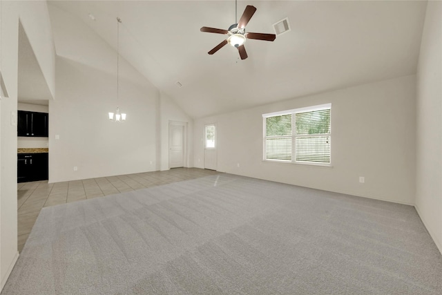 carpeted empty room featuring ceiling fan and high vaulted ceiling