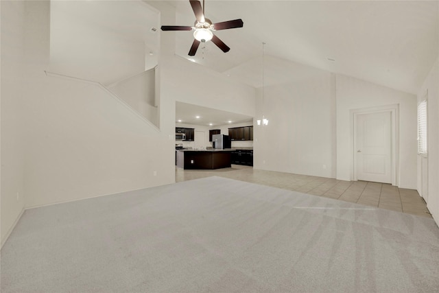 unfurnished living room with light colored carpet, high vaulted ceiling, and ceiling fan