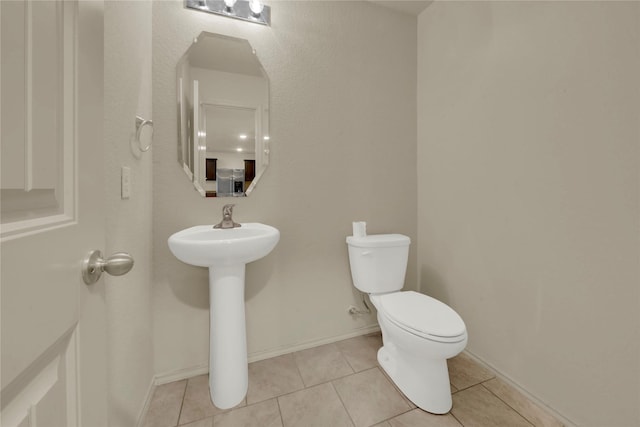 bathroom with tile patterned floors, sink, and toilet