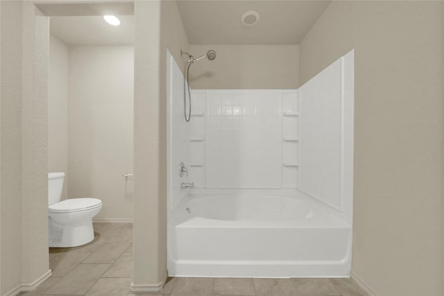 bathroom with tile patterned flooring, toilet, and shower / washtub combination