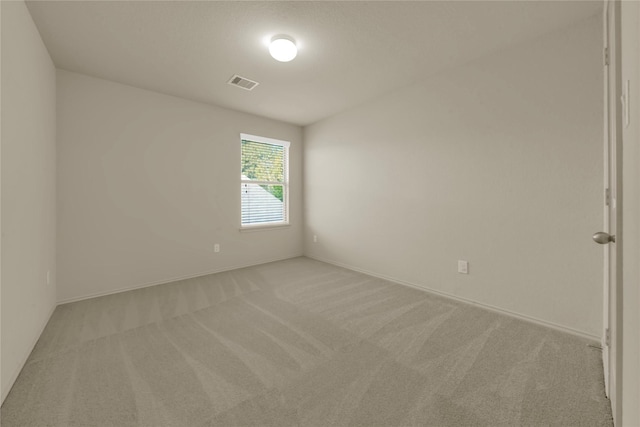 spare room with light carpet