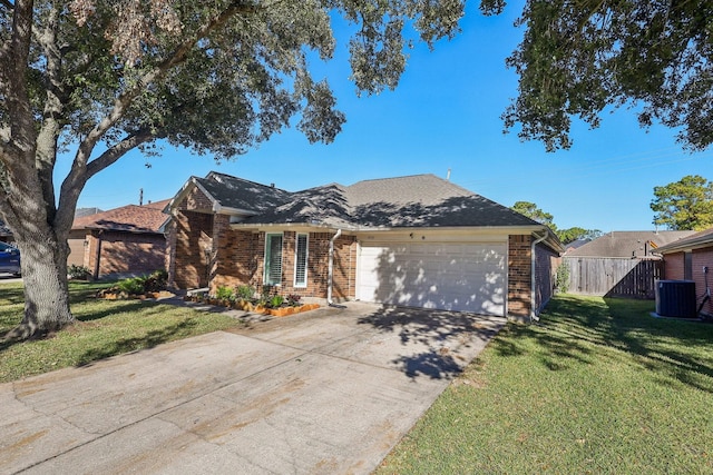 ranch-style home with cooling unit, a front yard, and a garage