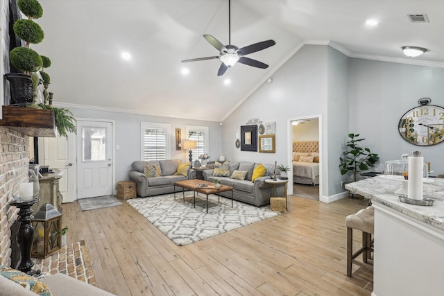 living room with light hardwood / wood-style floors, high vaulted ceiling, ceiling fan, and crown molding