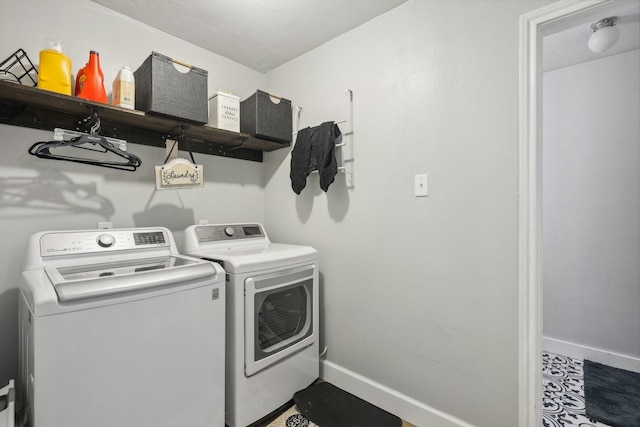 washroom featuring washer and clothes dryer