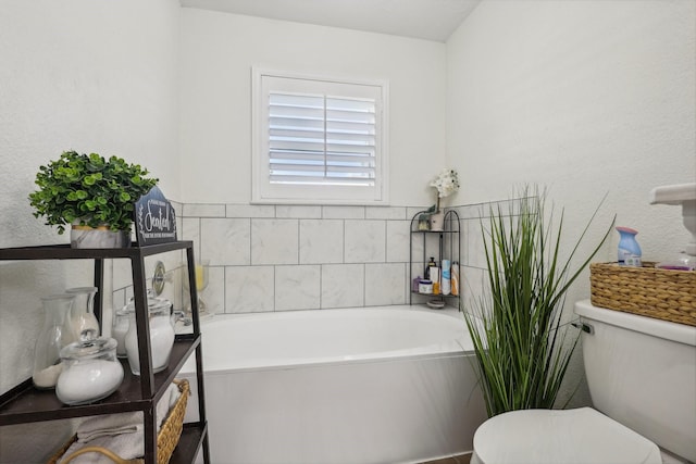 bathroom featuring a washtub and toilet