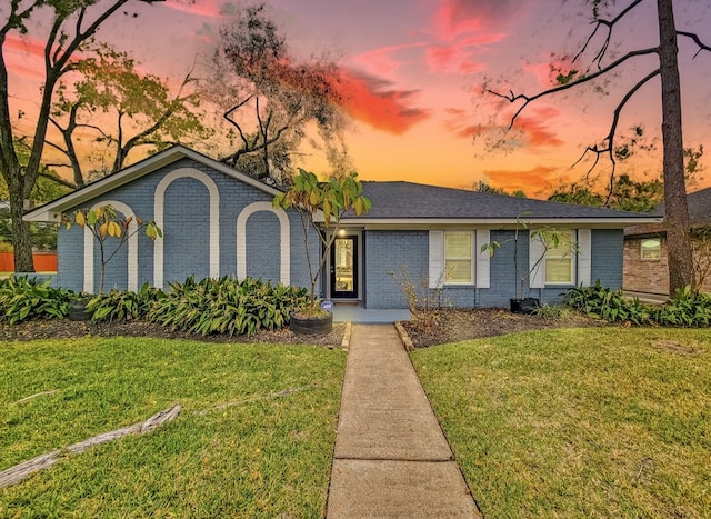 ranch-style house with a yard