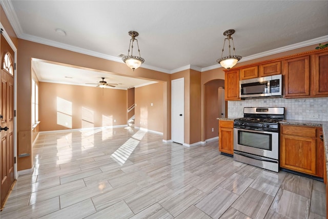 kitchen featuring appliances with stainless steel finishes, decorative light fixtures, ceiling fan, and crown molding