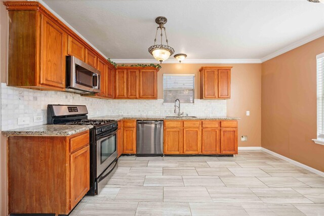 kitchen featuring crown molding, sink, light stone countertops, decorative light fixtures, and stainless steel appliances