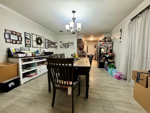 dining room featuring a notable chandelier and ornamental molding