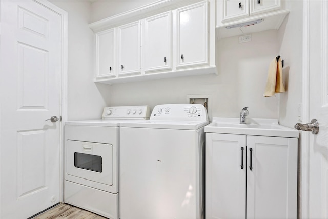 washroom featuring cabinets, independent washer and dryer, light hardwood / wood-style floors, and sink