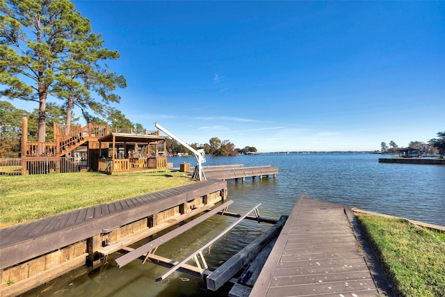 dock area with a yard and a water view