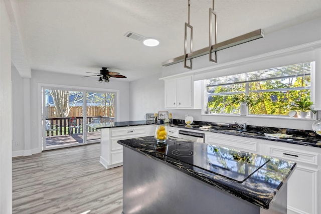 kitchen featuring white cabinetry, ceiling fan, light hardwood / wood-style flooring, stainless steel dishwasher, and black electric stovetop