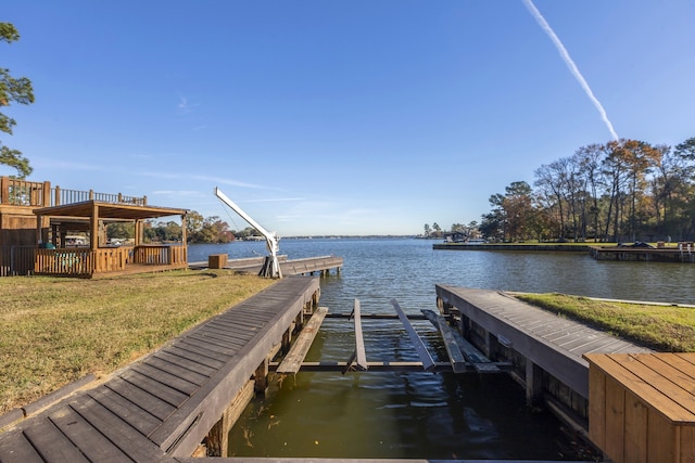 dock area featuring a lawn and a water view