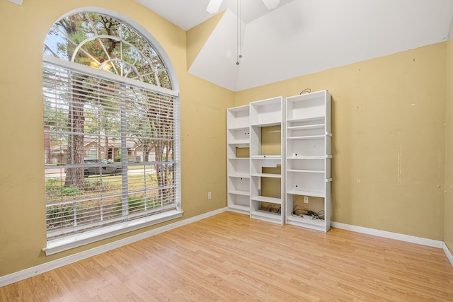 unfurnished bedroom featuring hardwood / wood-style flooring, ceiling fan, and lofted ceiling