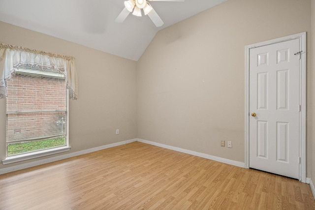 empty room featuring ceiling fan, lofted ceiling, and light hardwood / wood-style flooring