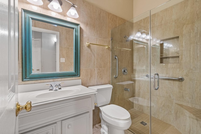 bathroom featuring tile patterned floors, vanity, toilet, and an enclosed shower