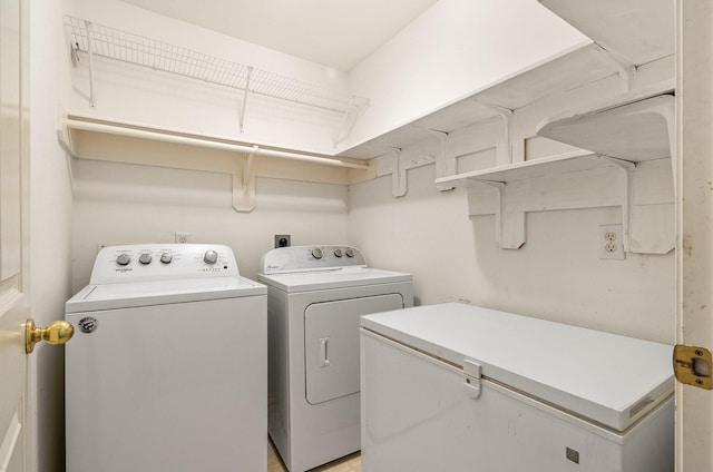 washroom with washing machine and clothes dryer