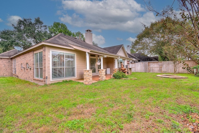 rear view of house with a yard