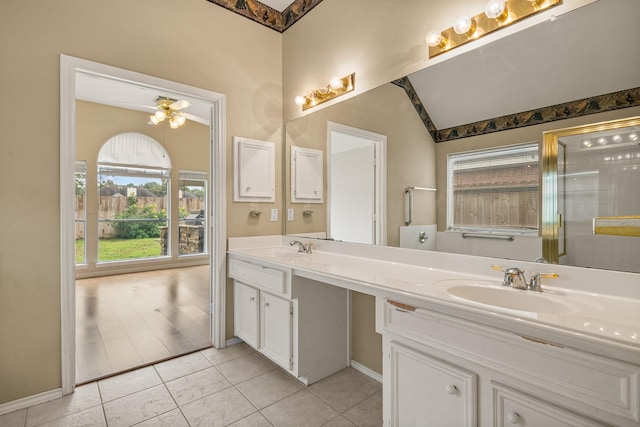 bathroom with an enclosed shower, vanity, vaulted ceiling, and ceiling fan