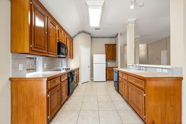 kitchen featuring black appliances, sink, ornate columns, tasteful backsplash, and light tile patterned flooring