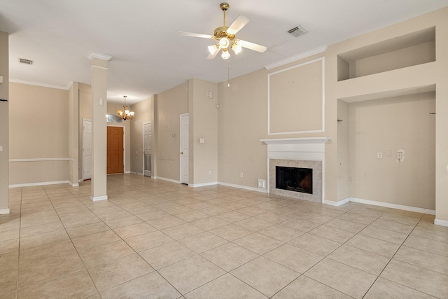 unfurnished living room with a tiled fireplace, crown molding, light tile patterned floors, and ceiling fan with notable chandelier