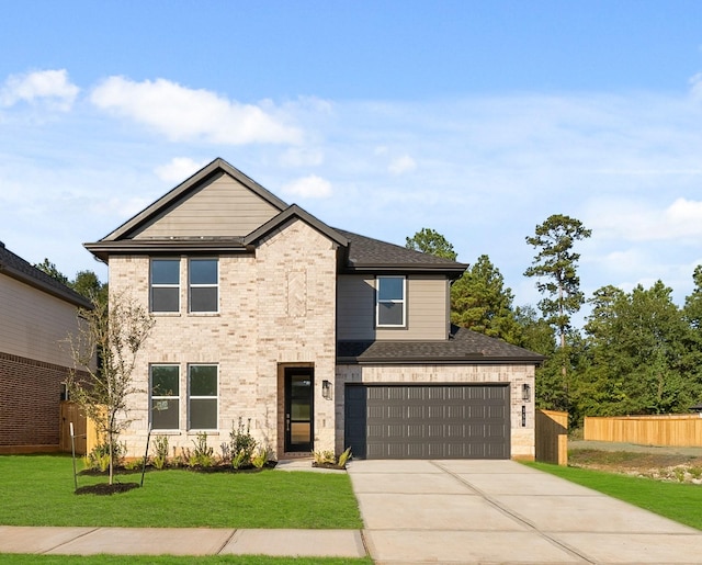 view of front of home featuring a front lawn and a garage