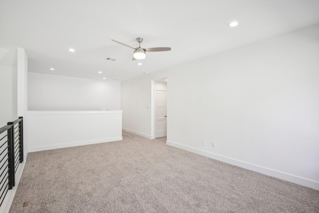 unfurnished room featuring ceiling fan and light colored carpet