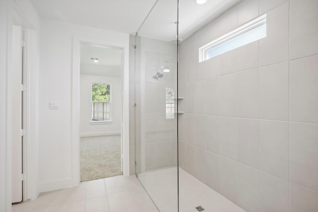 bathroom featuring a tile shower and tile patterned flooring