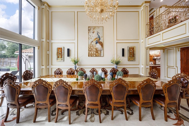 dining space with a towering ceiling and a notable chandelier