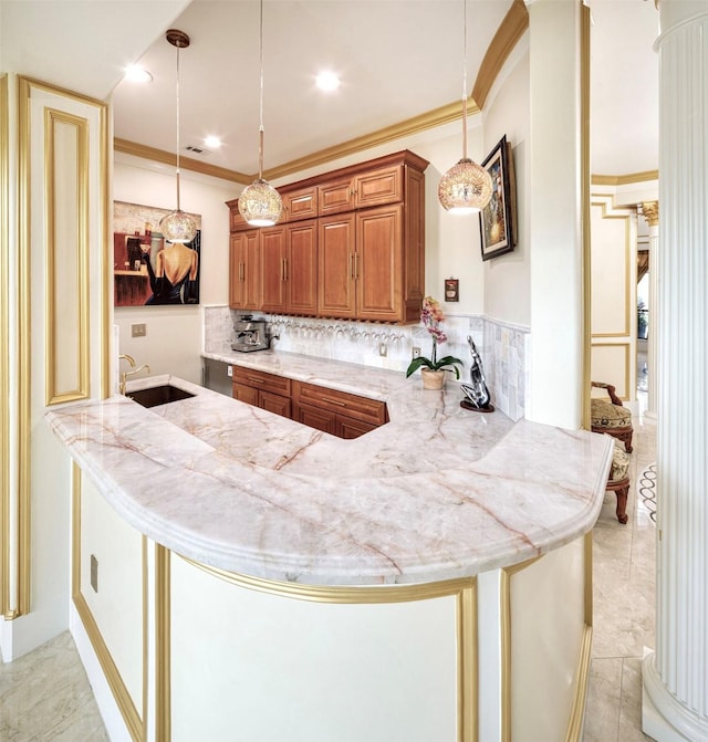 kitchen featuring kitchen peninsula, decorative light fixtures, tasteful backsplash, and sink