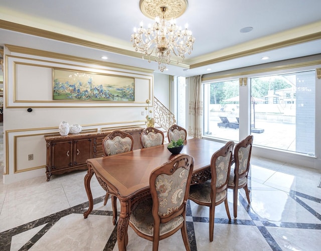 dining room with a tray ceiling and a chandelier