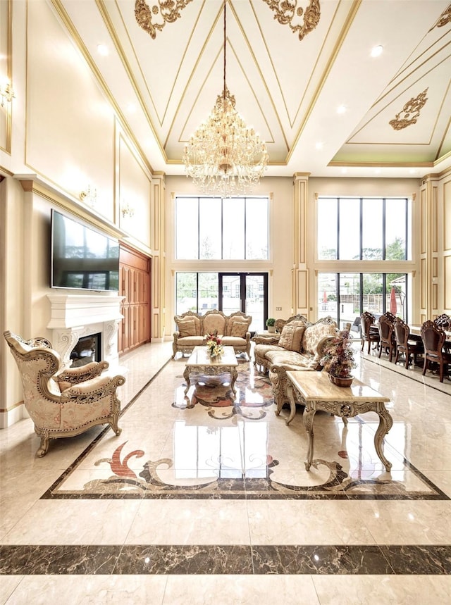 living room with a towering ceiling, crown molding, and an inviting chandelier