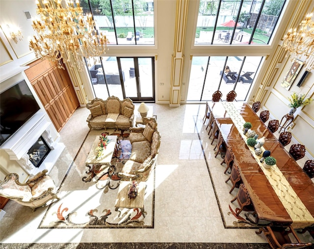 living room with a towering ceiling and a chandelier