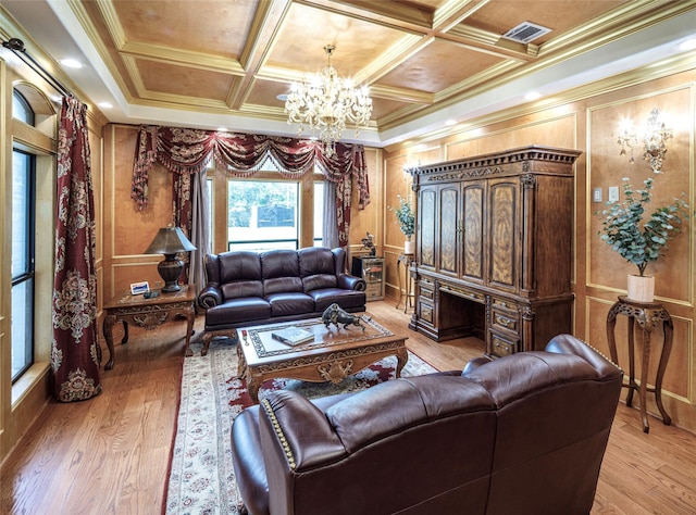 living room featuring light wood-type flooring, coffered ceiling, crown molding, beam ceiling, and a chandelier