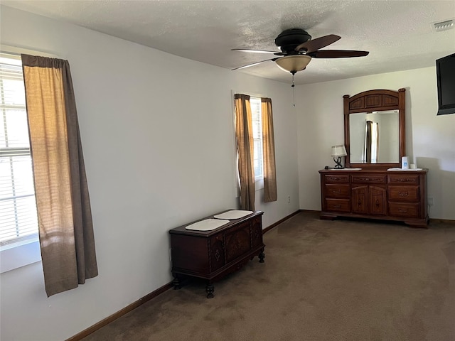 bedroom featuring carpet, stainless steel fridge, ceiling fan, and a textured ceiling