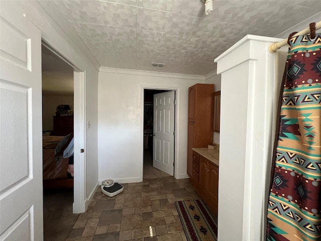 interior space featuring vanity and crown molding