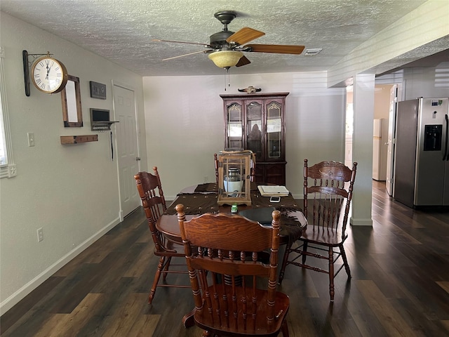 dining area with a textured ceiling, ceiling fan, and dark wood-type flooring