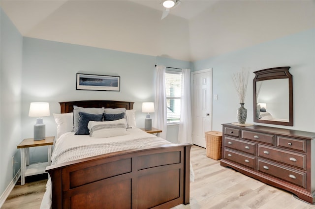 bedroom with lofted ceiling and light wood-type flooring