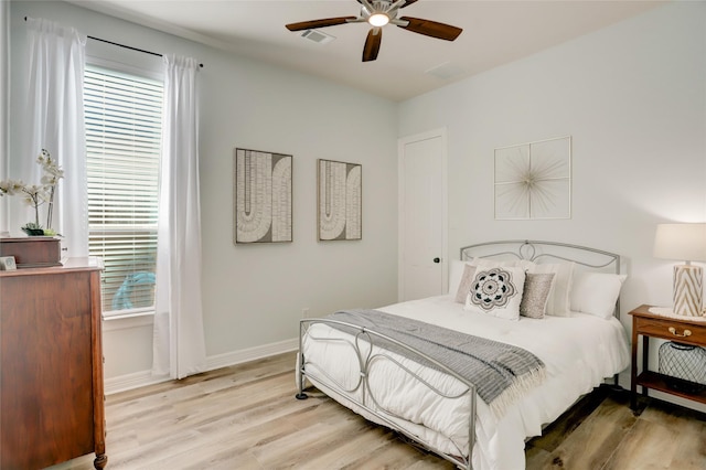 bedroom with ceiling fan and light wood-type flooring