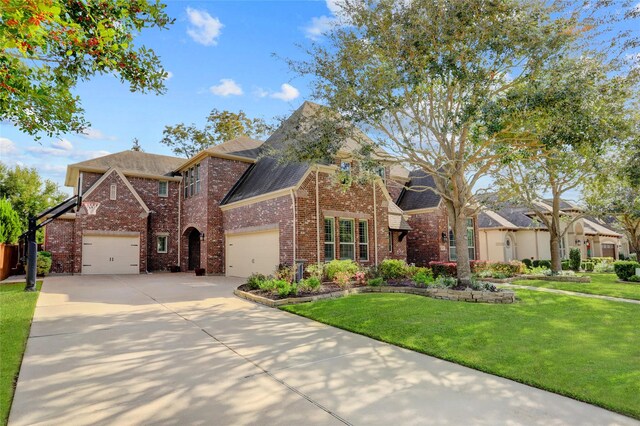 view of front of house featuring a front lawn and a garage