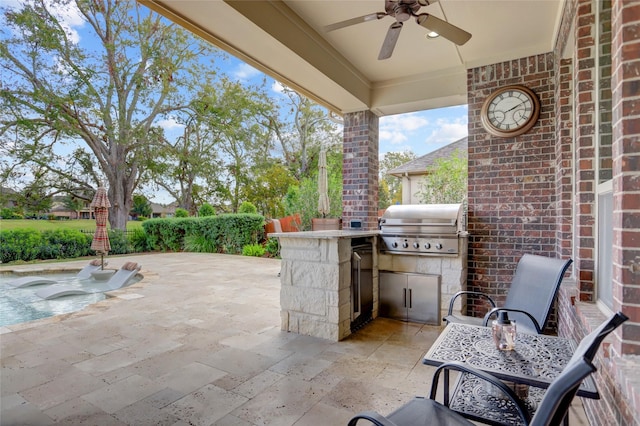 view of patio with grilling area, ceiling fan, and an outdoor kitchen