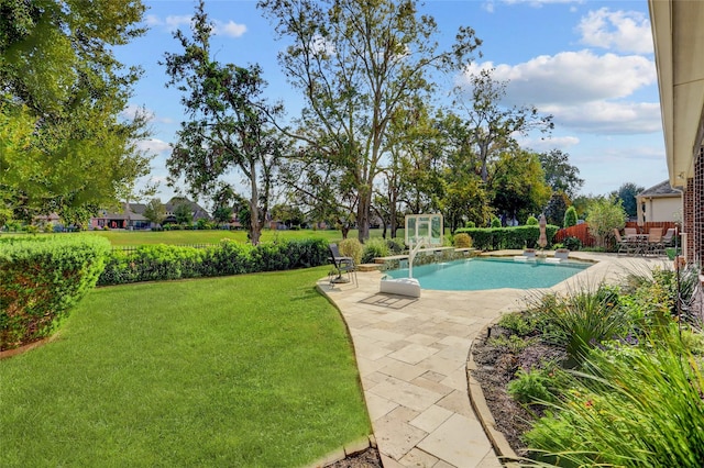 view of pool with a patio area and a yard