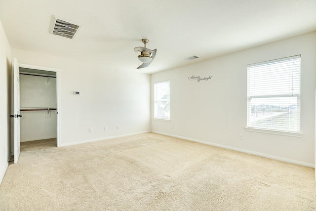 carpeted empty room featuring ceiling fan