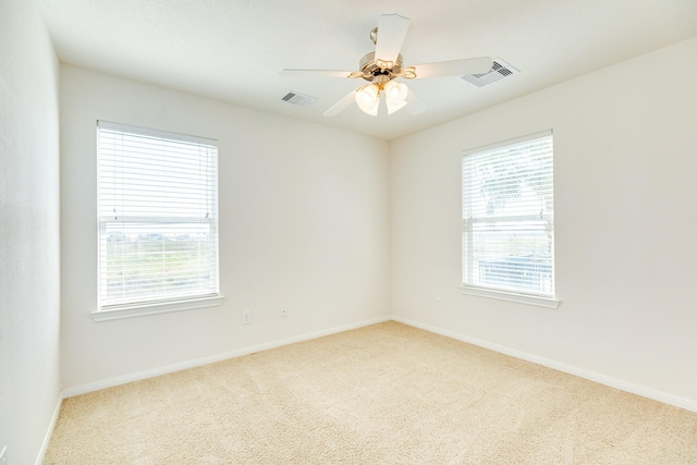 carpeted empty room featuring ceiling fan